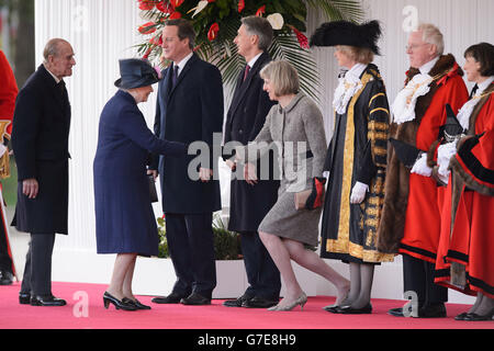 The Duke of Edinburgh looks on as Queen Elizabeth II shakes hands with Home Secretary Theresa May, with British Prime Minister David Cameron and Foreign Secretary Philip Hammond (centre) standing by as they attend the ceremonial welcome ceremony for Singapore's President Tony Tan Keng Yam at the start of a state visit at Horse Guards Parade in London. Stock Photo