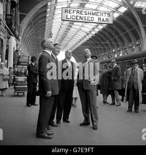 Dr Richard Beeching (R), Chairman of the British Railways Board, examines the newly-painted arch spans of Paddington Station's Brunel roof. With Dr Beeching are Mr S. E. Raymond (L), Mr G.A.V Phillips and Mr P. Peyman. Stock Photo