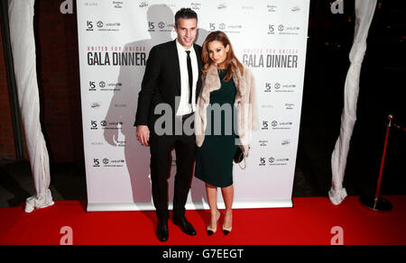 Robin van Persie and his wife Bouchra van Persie arrive at the United for UNICEF Gala Dinner attended by the Manchester United first-team and VIP guests at Old Trafford, Manchester. Stock Photo