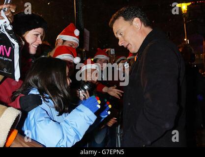 Actor Tom Hanks greets fans as he arrives for the UK premiere of his latest film The Polar Express, at the Vue Leicester Square in central London. Stock Photo