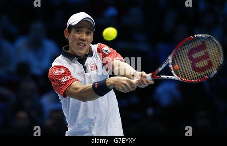 Kei Nishikori competes against Novak Djokovic during the Barclays ATP World Tour Finals at The O2 Arena, London. Stock Photo