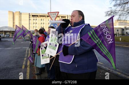 NHS health workers join the official picket line outside the Basingstoke and North Hampshire Hospital in Basingstoke, in protest at the Coalition's controversial decision not to accept a recommended 1% wage rise for all NHS employees. Stock Photo
