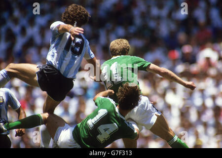 Aerial action shot of Argentina's Oscar Ruggeri tussling with West Germany's Thomas Berthold (14) and Karl-Heinz Rummenigge (r). Stock Photo