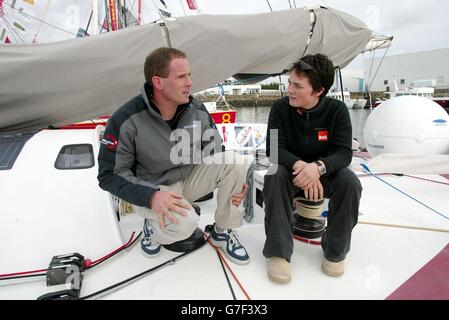 Record breaking round the world yachtswoman Ellen MacArthur chats with Conrad Humphreys from Plymouth aboard his boat Hollomoto in Les Sables d'Olonne. Conrad is in the resort to compete in the Vendee Globe, a single-handed non-stop circumnavigation of the planet which starts tomorrow. Ellen competed in the last event in 2000 coming second as the youngest person, and the fastest woman to complete the journey. Stock Photo