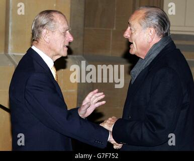 (left to right:) The Duke of Edinburgh greets French President Jacques Chirac at Windsor Castle. President Chirac arrived at Windsor Castle at 7.19pm for dinner with the Queen. He was driven to the castle's Quadrangle with his wife Bernadette in a Bentley and was greeted by the Duke of Edinburgh at the Sovereign's Entrance. As the couple's car entered the castle, some 2,000-odd pro-hunt campaigners roared deafeningly - heard easily inside the confines of Her Majesty's 1,000-year-old fortress. Stock Photo
