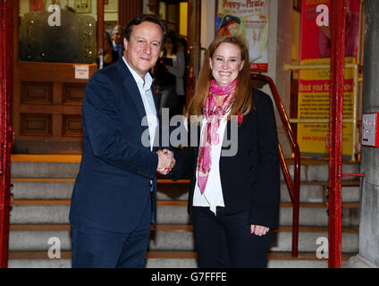 Prime Minister David Cameron with Kelly Tolhurst, the Conservative candidate in the Rochester and Strood by-election, pose for photographs as they leave the Brook Theatre in Chatham, Kent, following a community forum meeting. Stock Photo