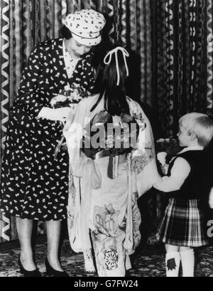 Queen Elizabeth II receives flowers at the opening of the Nippon Electric Company in Livingston, from eight-year-old Rie Manube and two-year-old Scot Martin Gold. Stock Photo