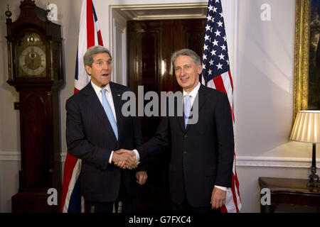 US Secretary of State John Kerry (left) and Foreign Secretary Philip Hammond shake hands before their breakfast meeting at 1 Carlton Gardens in London. Stock Photo