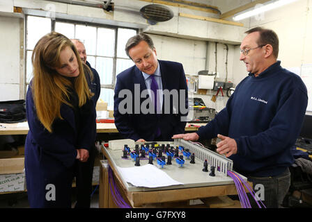 Prime Minister David Cameron with Kelly Tolhurst (left) Conservative Candidate for Rochester and Strood, talk to Mick Parks, Workshop Foreman at MCL Mechanical near Rochester, Kent, during a constituency visit ahead of the forthcoming by-election later this week. Stock Photo