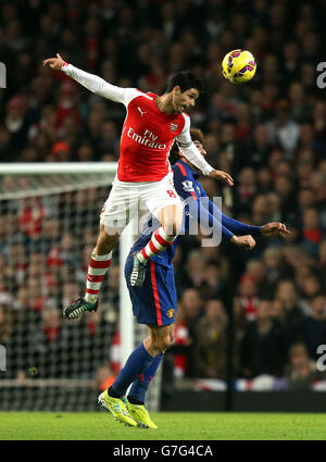 Manchester United's Marouane Fellaini (right) and Arsenal's Mikel Arteta (left) battle for the ball in the air