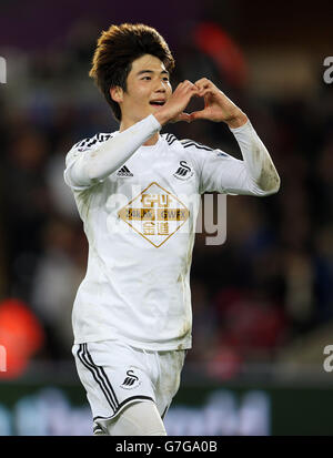 Swansea City's Ki Sung-Yueng celebrates scoring their first goal during the Barclays Premier League match at the Liberty Stadium, Swansea. Stock Photo