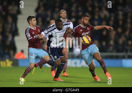 West Ham United's Aaron Cresswell and West Ham United's Winston Reid challenge together to win ball of West Bromwich Albion's Victor Anichebe during the Barclays Premier League match at The Hawthorns, West Bromwich. Stock Photo