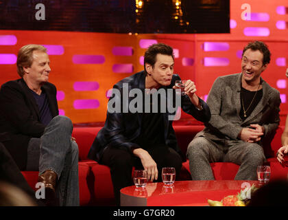 Guests (left to right) Jeff Daniels, Jim Carrey and Jude Law during filming of the Graham Norton Show at the London Studios, south London. Stock Photo