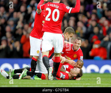 Soccer - Barclays Premier League - Manchester United v Liverpool - Old Trafford. Manchester United's Wayne Rooney, bottom right is mobbed by Team mates after putting Manchester united 1-0 up Stock Photo