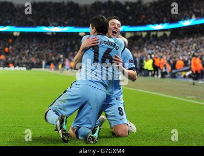 Manchester City's Sergio Aguero (left) celebrates scoring his sides third goal of the game alongside teammate Samir Nasriduring the UEFA Champions League match at the Etihad Stadium, Manchester. Stock Photo