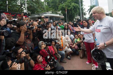 Mayor of London Boris Johnson cycles through the streets of Jakarta on Car Free Sunday when cars are banned from the city centre while on a week long visit to the Far East taking in Singapore, Malaysia and Indonesia to promote investment in London. Stock Photo