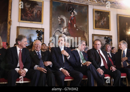 Foreign Secretary Philip Hammond (left) talks with US Secretary of State John Kerry (centre), at the London Conference on Afghanistan at Lancaster House in central London. Stock Photo