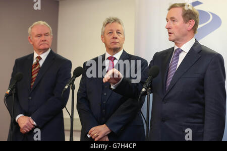 Taoiseach Enda Kenny speaks to the media, as Northern Ireland Deputy First Minister Martin McGuinness (left) and Northern Ireland First Minister Peter Robinson look on at the North South Ministerial Council meeting in Armagh. Stock Photo
