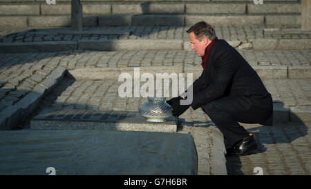 Prime Minister David Cameron lays a candle by the memorial at the Birkenau extermination camp in Poland, during a personal visit that he made to the former concentration camps of Auschwitz and Birkenau for the first time since becoming Prime Minister. Stock Photo