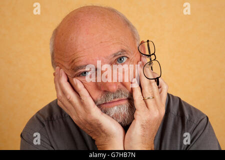 Elderly man, 59, sad expression, depressed Stock Photo