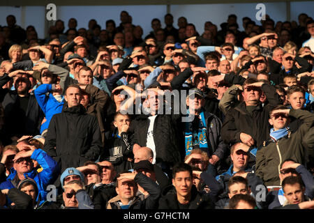 Manchester City fans shield their eyes from the sun in the stands during the Barclays Premier League match at St Mary's Stadium, Southampton. PRESS ASSOCIATION Photo. Picture date: Sunday November 30, 2014. See PA story SOCCER Southampton. Photo credit should read Nick Potts/PA Wire. . . Stock Photo