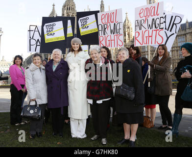 Gemma Arterton (centre) with original Dagenham women strikers (front row left to right) Gwen Davis, Eileen Pullen, Vera Sime and Sheila Douglass, and cast of the musical Made in Dagenham during a photocall with original Dagenham ladies outside the Houses of Parliament, London, to coincide with a Labour bid to force big firms to publish the difference in pay between male and female employees. Stock Photo