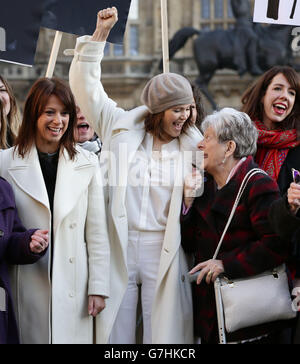 Gemma Arterton (centre), Labour MP Gloria De Piero (left) and original Dagenham women striker Vera Sime with cast of the musical Made in Dagenham during a photocall with original Dagenham ladies outside the Houses of Parliament, London, to coincide with a Labour bid to force big firms to publish the difference in pay between male and female employees. Stock Photo