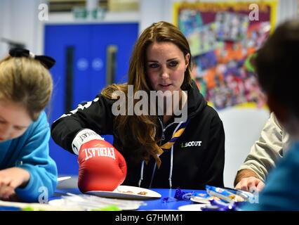 The Duchess of Cambridge learns about disability by wearing a boxing glove to undertake simple tasks as she meets with children at the newly established 23rd Poplar Beaver Scout Colony in east London. Stock Photo