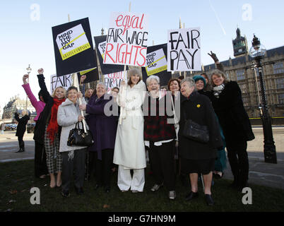 Gemma Arterton (centre) with original Dagenham women strikers (front row left to right) Gwen Davis, Eileen Pullen, Vera Sime and Sheila Douglass, and cast of the musical Made in Dagenham during a photocall outside the Houses of Parliament, London, to coincide with a Labour bid to force big firms to publish the difference in pay between male and female employees. Stock Photo