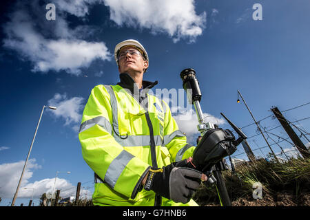 Surveyor on site using surveying equipment Stock Photo