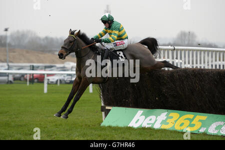 Cantlow ridden by jockey Barry Geraghty jumps the last on the first circuit during the Bet365 Open Handicap Chase during day 2 of the bet365 Hennessy Festival at Newbury Racecourse, Berkshire Stock Photo