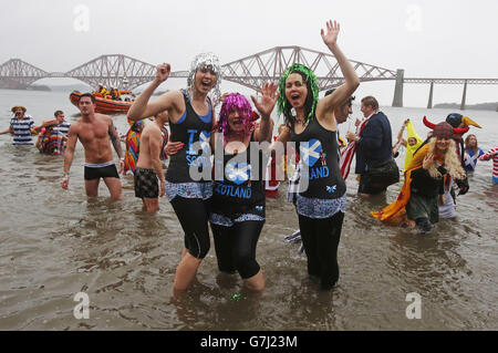 Swimmers take part in the Loony Dook New Year's Day dip in the Firth of Forth at South Queensferry, as part of Edinburgh's Hogmanay celebrations. Stock Photo