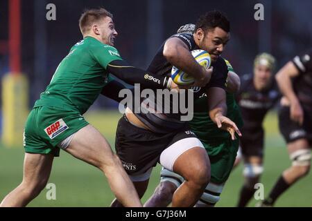 Saracens Billy Vunipola is tackled by London Irish's Alex Lewington and Kieran Low during the Aviva Premiership match at Allianz Park, London. Stock Photo