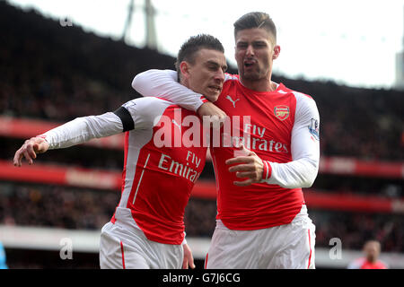 Arsenal's Laurent Koscielny (left) celebrates scoring his sides first goal of the game with team mate Olivier Giroud (right) Stock Photo