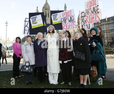 Gemma Arterton (centre) with original Dagenham women strikers (front row left to right) Gwen Davis, Eileen Pullen, Vera Sime and Sheila Douglass, and cast of the musical Made in Dagenham during a photocall with original Dagenham ladies outside the Houses of Parliament, London, to coincide with a Labour bid to force big firms to publish the difference in pay between male and female employees. Stock Photo