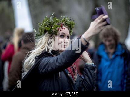 A woman takes a 'selfie' picture at Stonehenge, Witshire, where people are gathering to celebrate the Winter solstice. Stock Photo