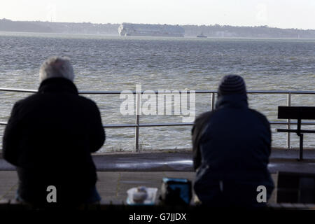 The car carrier Hoegh Osaka near Lee-on-the-Solent, Hampshire, is towed to a holding position after it re-floated on the high tide. Stock Photo