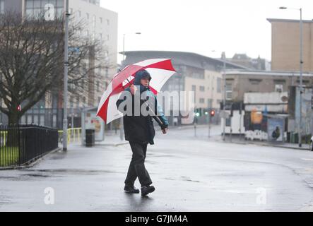 A man with an umbrella in Glasgow, Scotland, as bad weather continues to hit the UK. Stock Photo