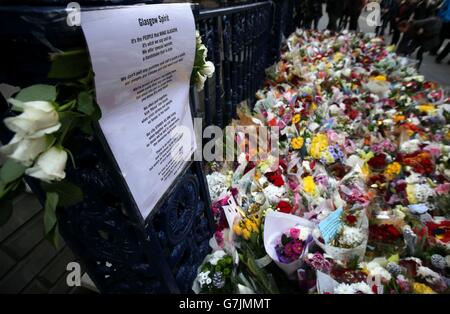 Flowers left at Ingram Street in Glasgow as police remove the cordons at the scene of yesterday's bin lorry crash in Glasgow. Stock Photo