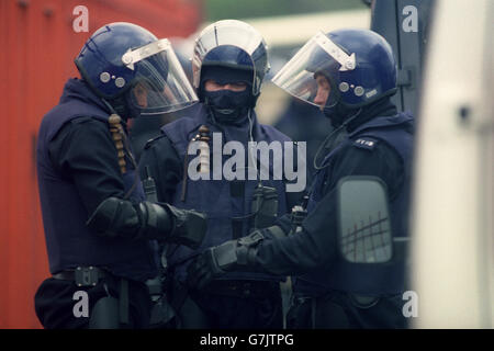 Police officers prepare their riot clothing outside the Strangeways ...
