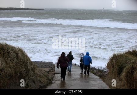 People go for a walk along the beach at Rosses Point, Co. Sligo, as bad weather continued across Britain and Ireland. Stock Photo