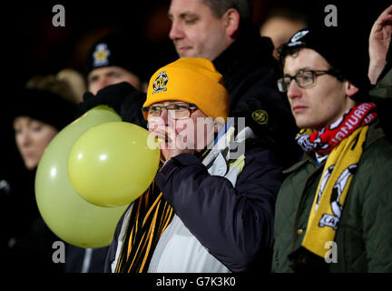 Cambridge United fans show support for their team with balloons in the stands Stock Photo