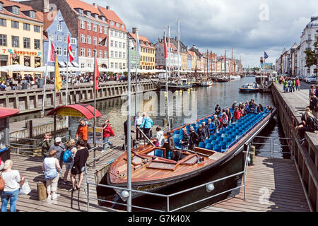 Passengers disembarking from a canal tour boat in Nyhavn Copenhagen Denmark Stock Photo