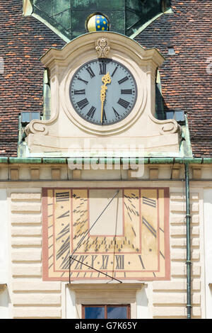 Sundial and clock in facade of Amalienburg, part of Hofburg Imperial Palace on In der burg square in Vienna, Austria Stock Photo