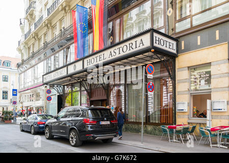 Street scene of Fuhrichgasse with entrance of Hotel Astoria, people and cars in inner city of Vienna, Austria Stock Photo