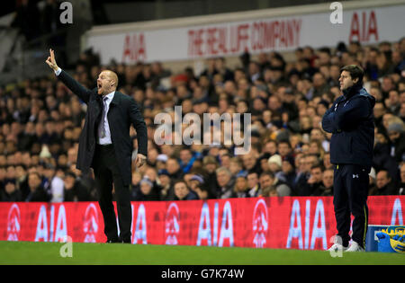 Burnley manager Sean Dyche (left) and Tottenham manager Hotspur Mauricio Pochettino during the FA Cup Third Round replay at White Hart Lane, London. Stock Photo