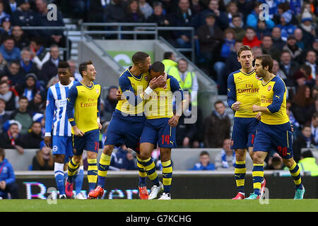 Arsenal's Theo Walcott (centre right) celebrates scoring his side's first goal with teammates during the FA Cup Fourth Round match at the AMEX Stadium, Brighton. Stock Photo