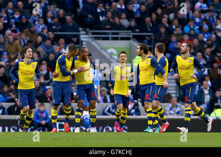 Arsenal's Theo Walcott (centre left) celebrates scoring his side's first goal with teammates during the FA Cup Fourth Round match at the AMEX Stadium, Brighton. Stock Photo