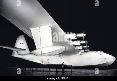 The largest flying boat airplane ever built, nicknamed the 'Spruce Goose,'  made its one and only flight in 1947 and is now on display at the Evergreen Aviation and Space Museum in McMinnville, Oregon, USA. Howard Hughes and his California-based aircraft company designed, built and flew the all-wood seaplane that weighed 180 tons (163293 kilograms). Officially named the Hughes H-4 Hercules, it was developed for service in World War II but that conflict was over before the plane's test flight that climbed only 70 feet (21 meters), covered about one mile (1.6 kilometers), and lasted one minute. Stock Photo