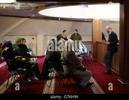 A member of staff speaking to visitors on a tour of Finsbury Park Mosque in north London, during a national #VisitMyMosque day organised by the Muslim Council of Britain, where British mosques opened their doors to the general public. Stock Photo